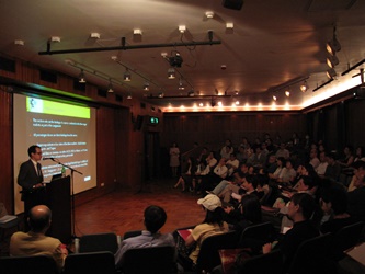 A representative of the survey firm briefs the audience on the survey results