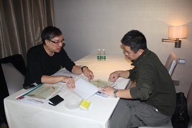 Producer Weldon Fung introduces the conceptual drawings of his project to a Mainland film investor