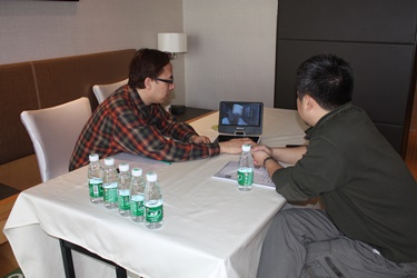 Director Ray Leung shows clips of his project to a Mainland film investor