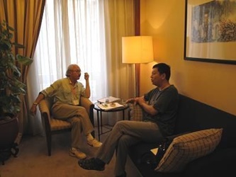 Director Dennis Chan discusses his project with a Beijing film investor