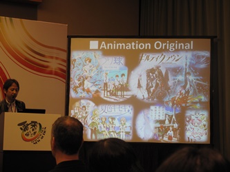 Powerpoint presentation showcasing cases of comics and multi-media collaboration is shown at the Symposium