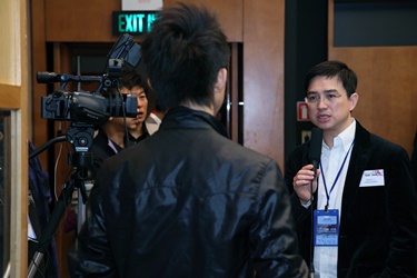 Guest speaker Mr. Alan Wan is interviewed by the media after a panel discussion