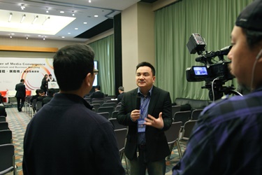 Guest speaker Mr. James Zhao is interviewed by the media after a panel discussion