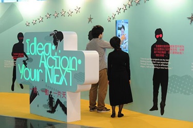 Visitors try the interactive multi-media devices