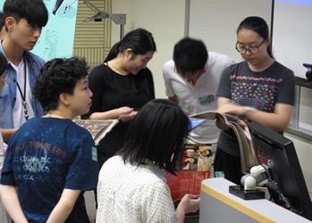 Seminar participants read the film promotional brochures