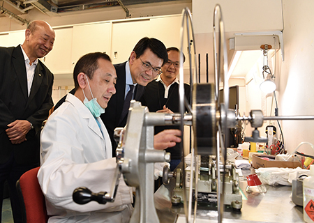 The Secretary for Commerce and Economic Development, Mr Edward Yau (third left), today (June 14) visits the Hong Kong Film Archive during his visit to Eastern District to learn about the work of its Conservation Unit.