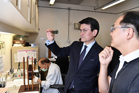 The Secretary for Commerce and Economic Development, Mr Edward Yau (second right), today (June 14) visits the Hong Kong Film Archive during his visit to Eastern District to learn about the work of its Conservation Unit.